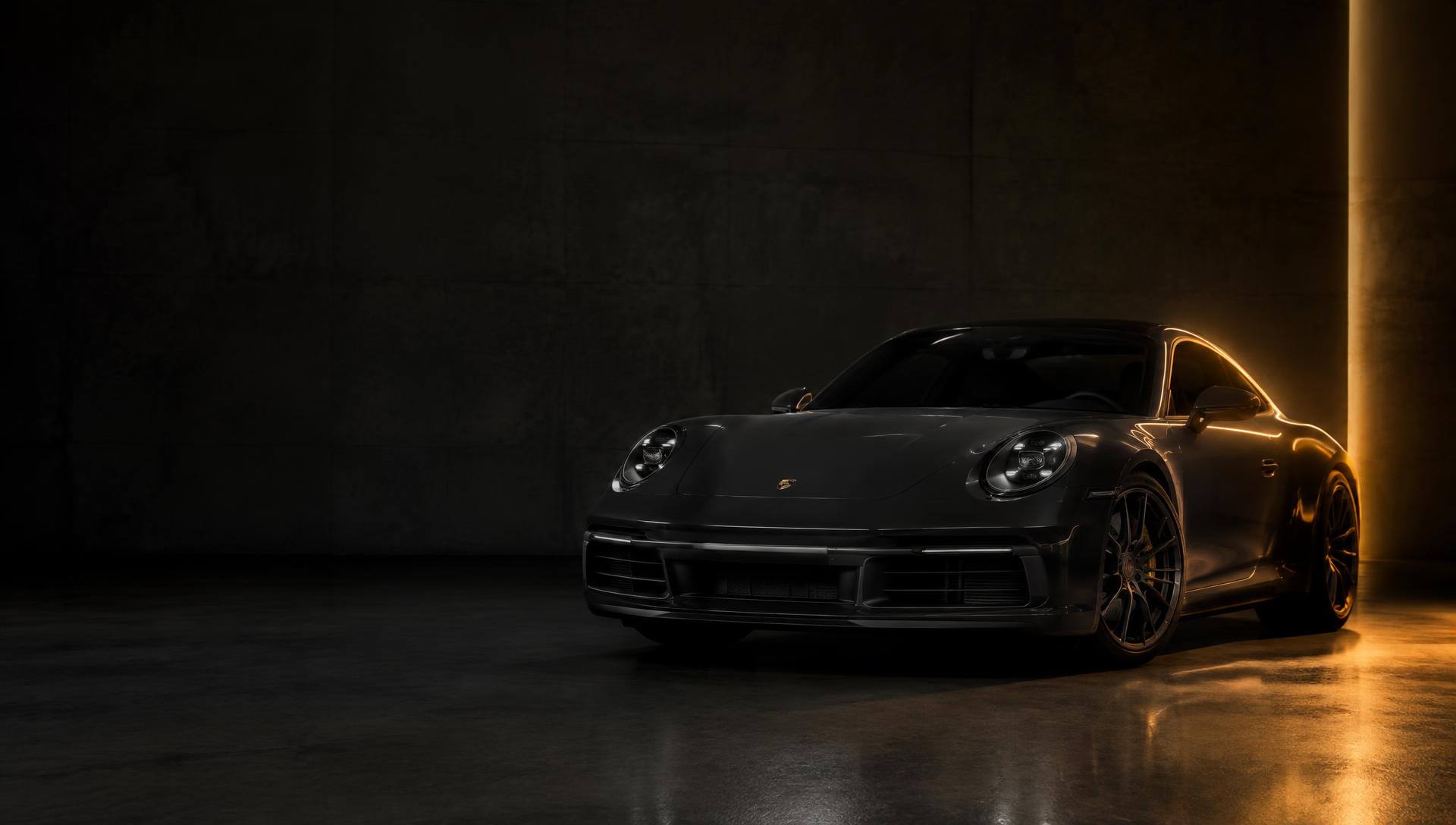 Dark Porsche 911 in a dim showroom